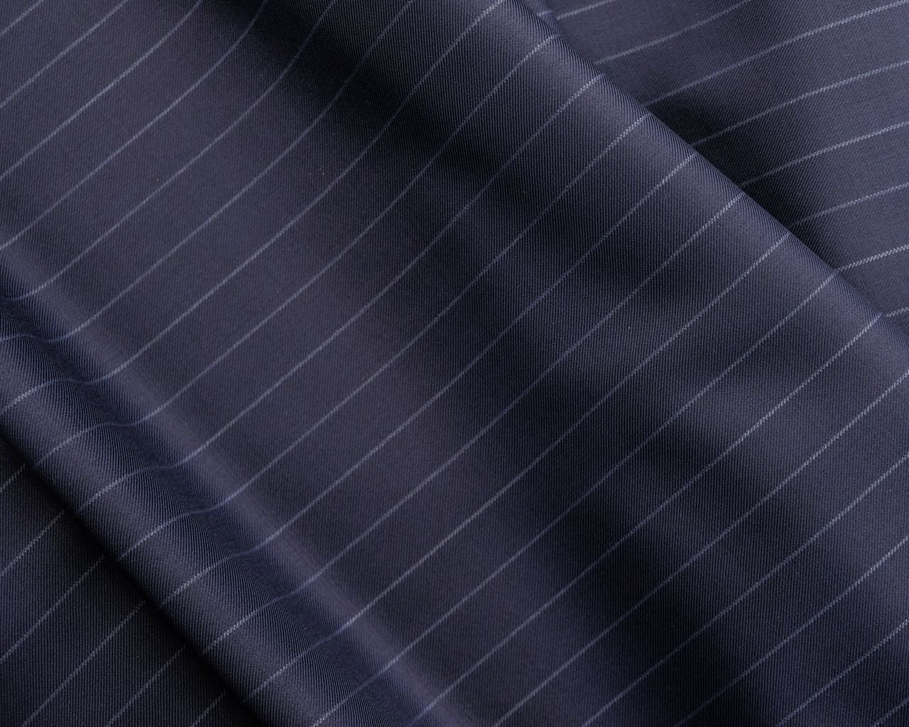 From above of dark blue shiny smooth suite fabric with elegant striped pattern