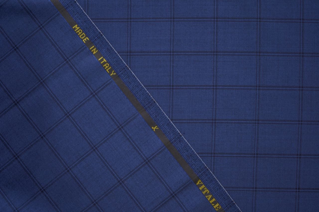 Top view of blue elegant suit fabric with geometric patterns and made in Italy inscription